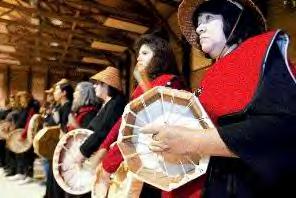 Trudy Marcellay of the Chehalis tribe played the drum Saturday with members of other tribes at the Port Gamble S'Klallum Night of Song. photo by Carolyn J. Yaschur
