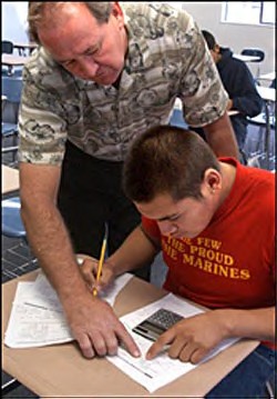 Teacher Greg Fleming helps a student