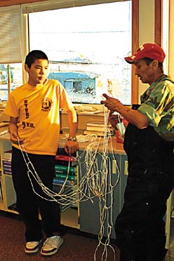 Damien Otten of St. Michael shows a new fisherman how to use braided twine, because it is stronger and picks up less dirt. Tom caught whales last year, but even more in 2000. "I gave most of them away," he said. 